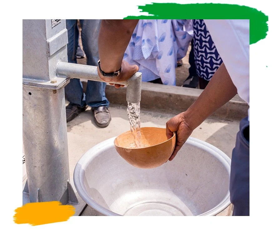 A completed borehole with a hand pump.