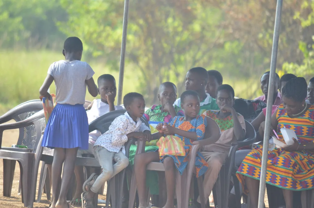 Children from the community waiting with gleam and joyA beautiful team work with the Ochs Family