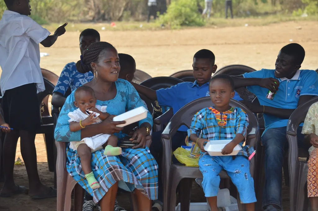 Members of the community in joy as they are been served